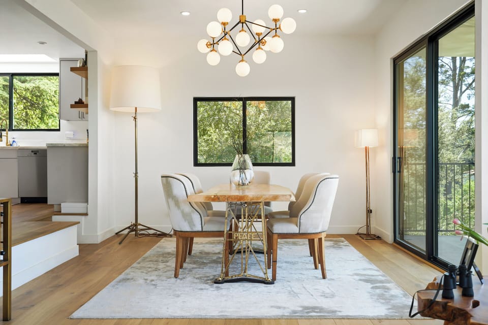 Elegant dining area with seating for eight, framed by stunning hillside vistas.