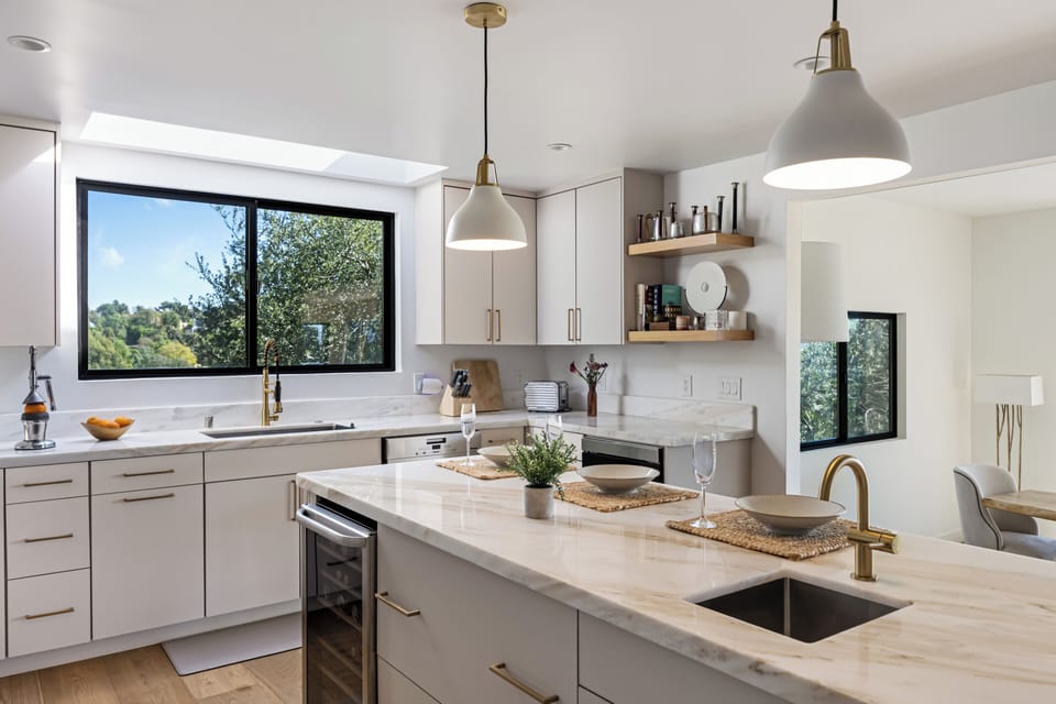 A beautifully styled kitchen island with bar seating for casual breakfasts and evening drinks.