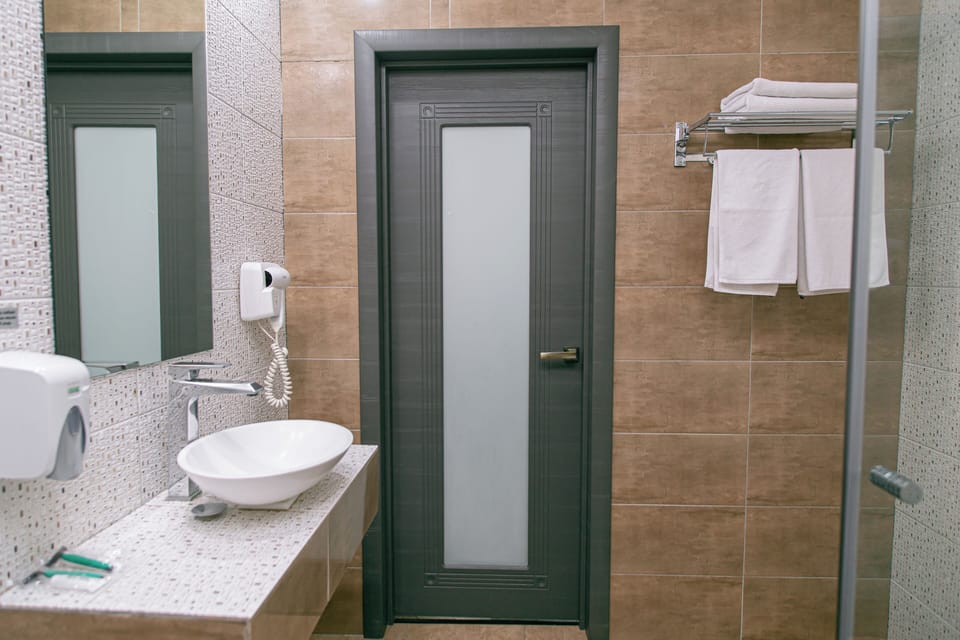 Junior Suite, Balcony, City View | Bathroom | Free toiletries, hair dryer, slippers, towels