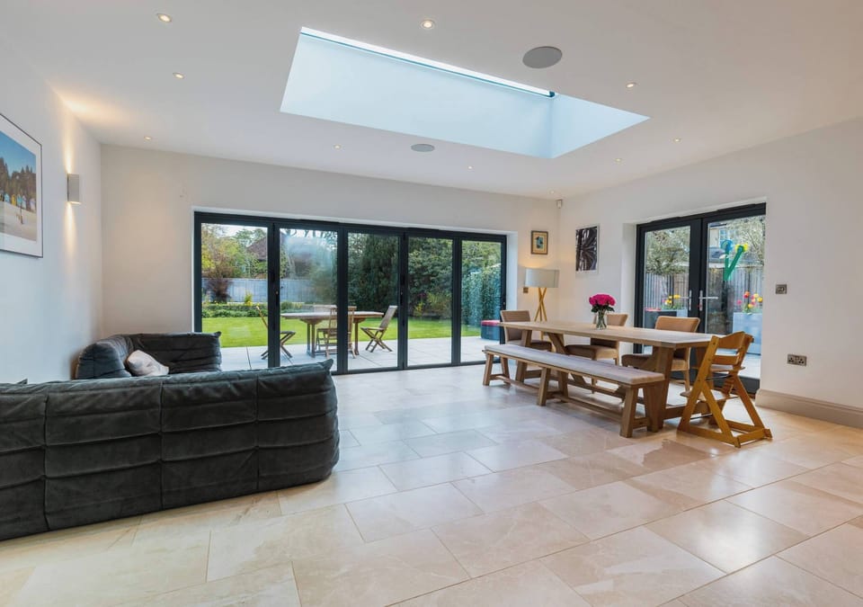 Bright open-plan kitchen, dining and lounge with bi-fold doors that lead to the garden.