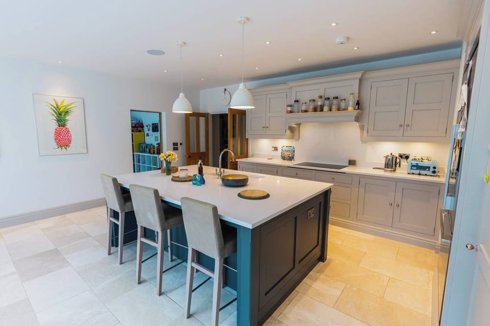 Spacious kitchen with central island seating, perfect for group breakfasts and relaxed dining.