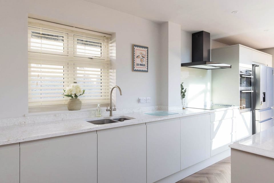 Modern coastal bungalow with bright interiors, high-end kitchen, and a relaxed, welcoming atmosphere throughout.