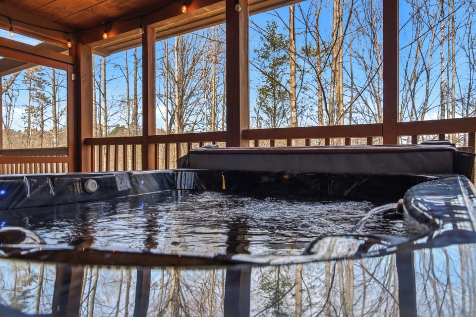 Sink into your private hot tub and let winter's crisp air kiss your cheeks while warm waters embrace you beneath the covered deck.