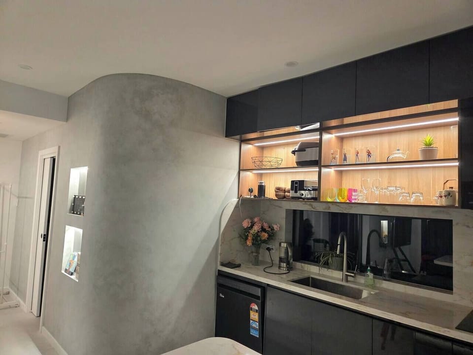 Contemporary kitchen layout with ample bench space and ambient lighting.