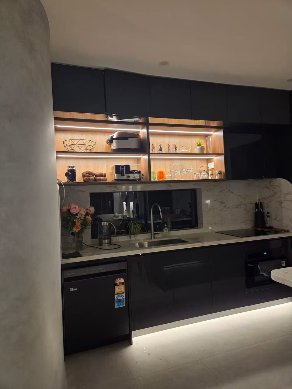 Fully equipped kitchen featuring induction cooking, oven, fridge and essential c