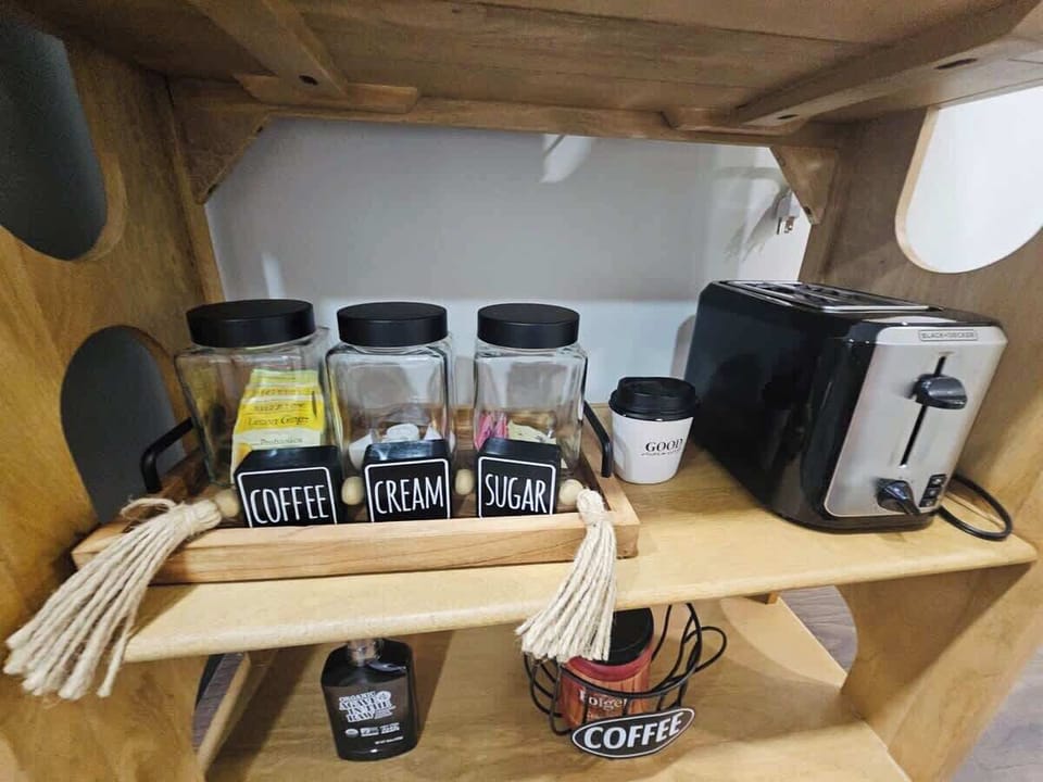 The coffee bar includes coffee, sugar, cream, and a toaster for your convenience.

