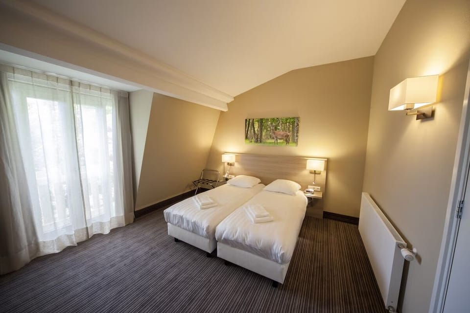 Unwind in a warm, quiet room with soft linens.