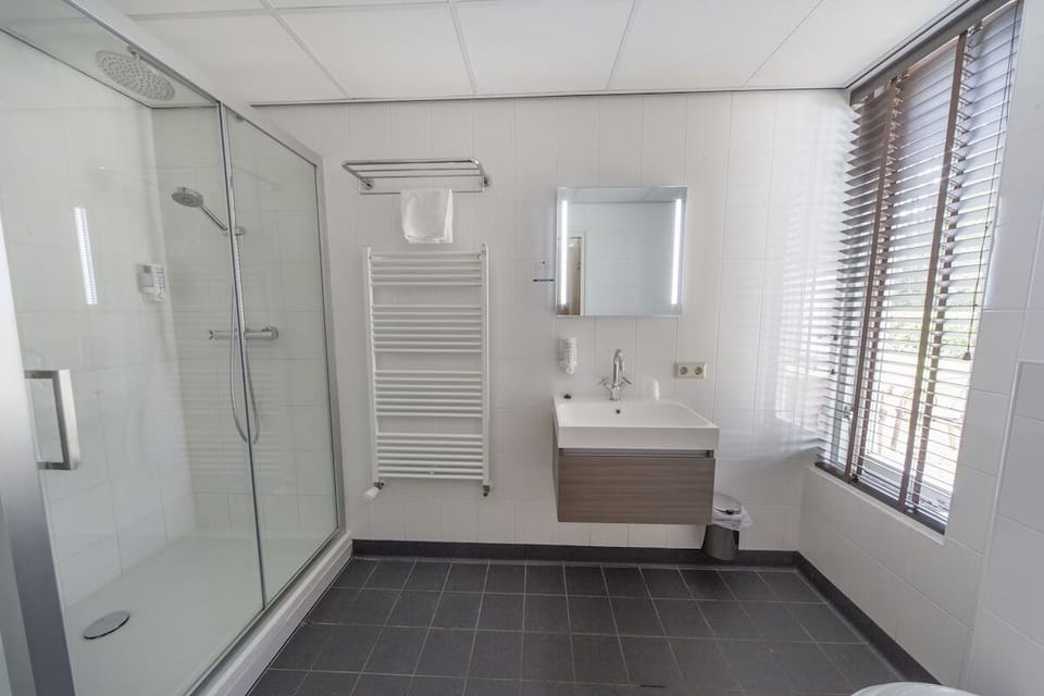Refresh after exploring with a bright, spacious walk-in shower.