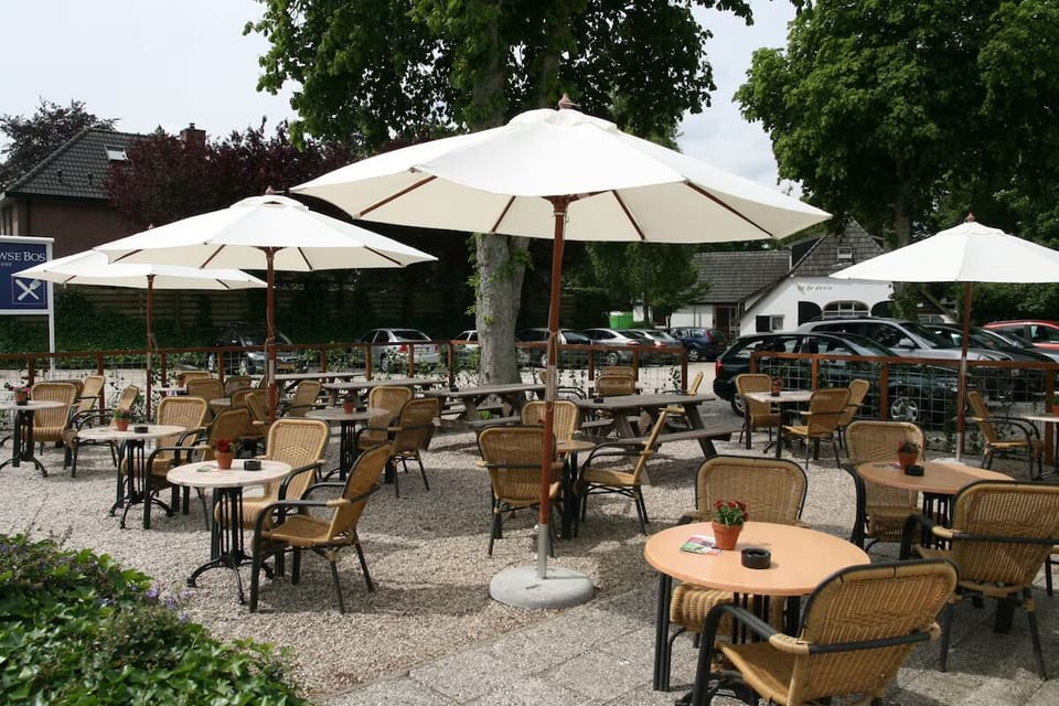 Sip and relax outdoors under umbrellas on the sunny terrace.