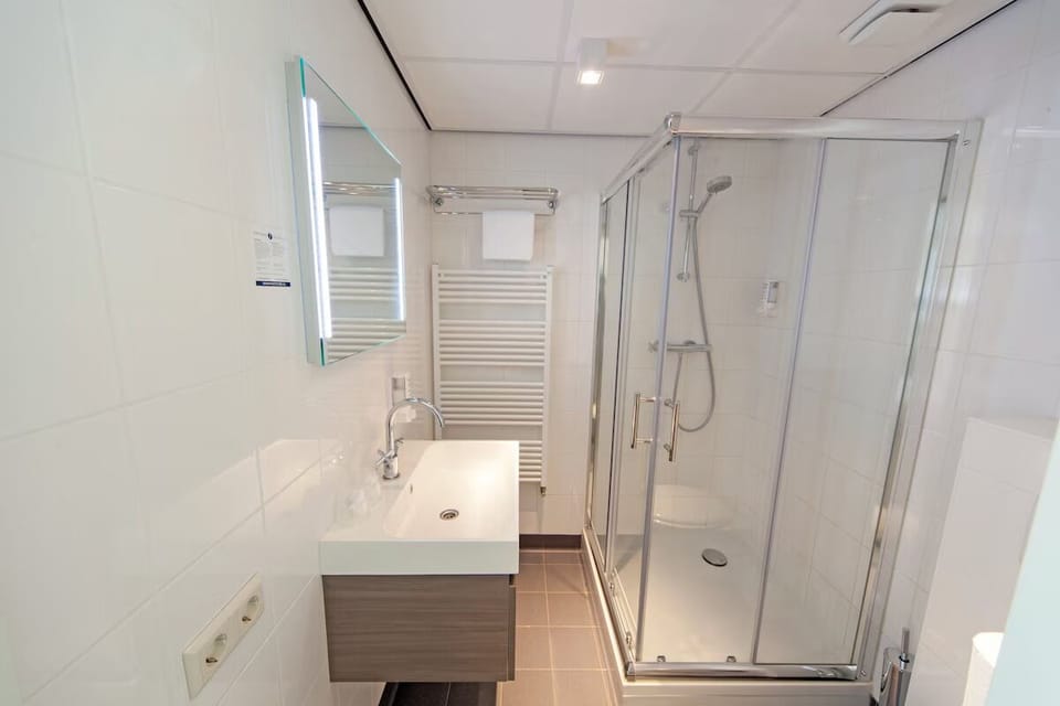 Refresh in a spotless, modern bathroom with walk-in shower.