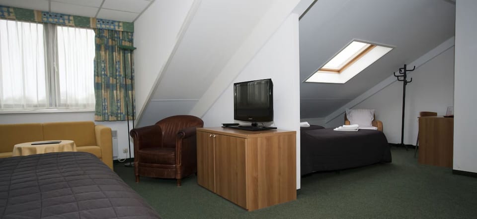 Unwind in a spacious loft-style bedroom with cozy seating.