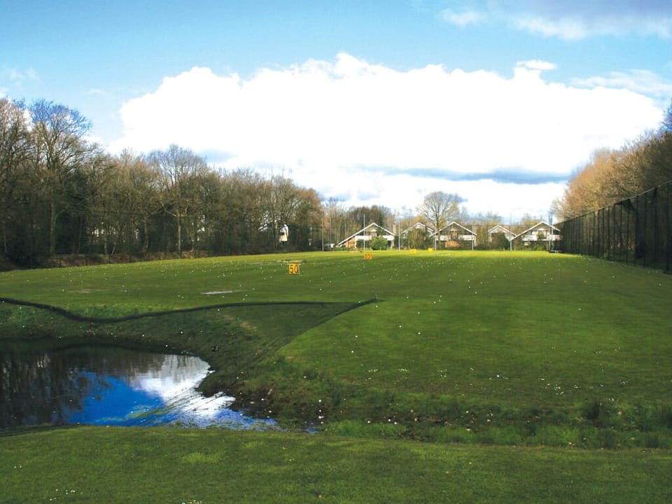Practice your swing beside serene water and open fairways.