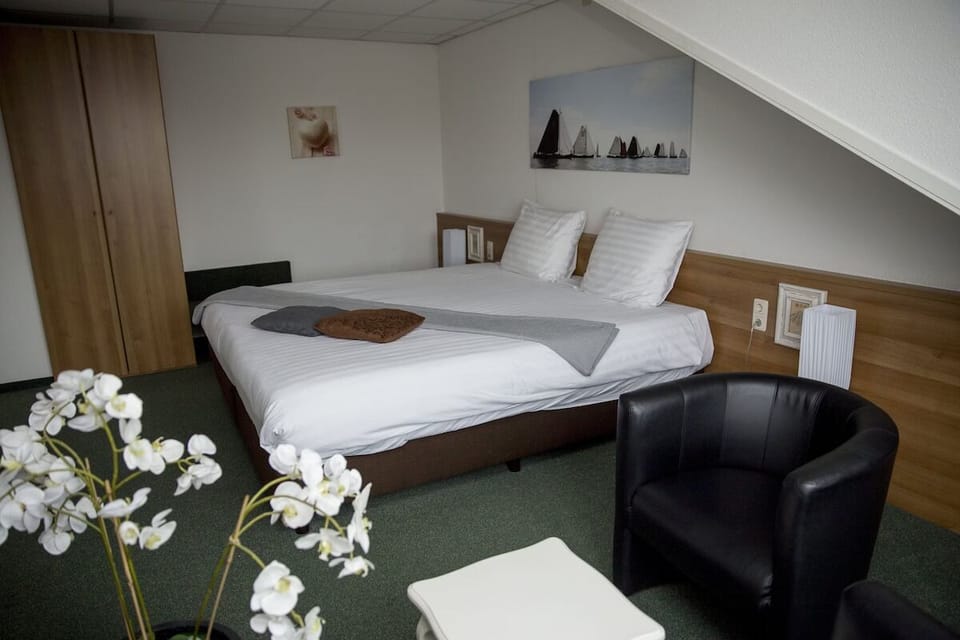 Stretch out comfortably on a plush bed under sloped ceilings.