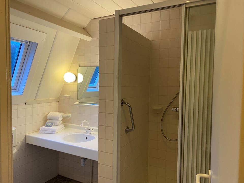 Refresh effortlessly in a bright bathroom with a roomy shower.
