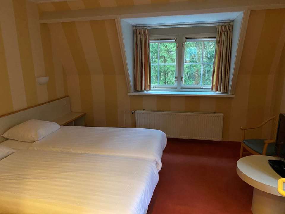 Settle into twin beds with peaceful views and soft light.