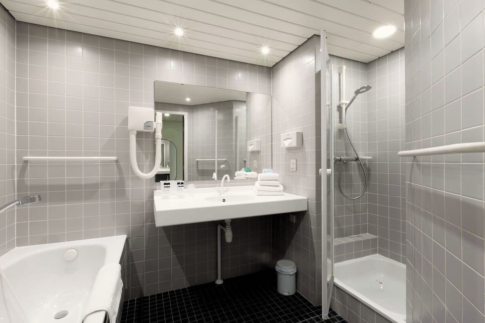 Refresh in a bright, modern bathroom with sleek shower space.