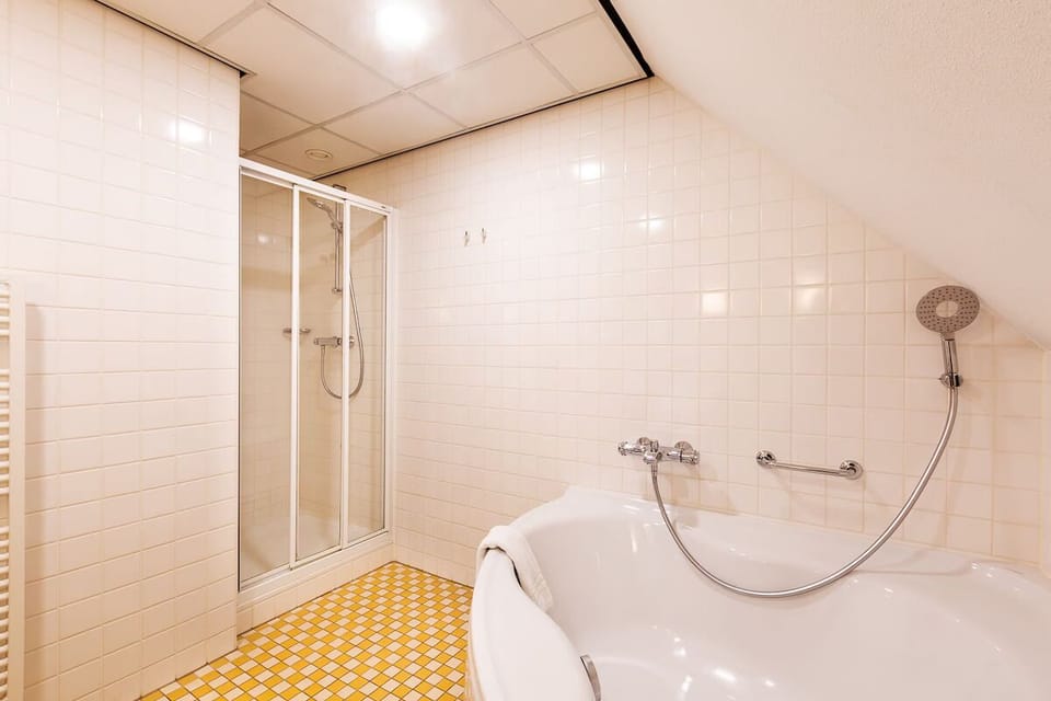 Soak or shower comfortably in a clean, spacious bath area.