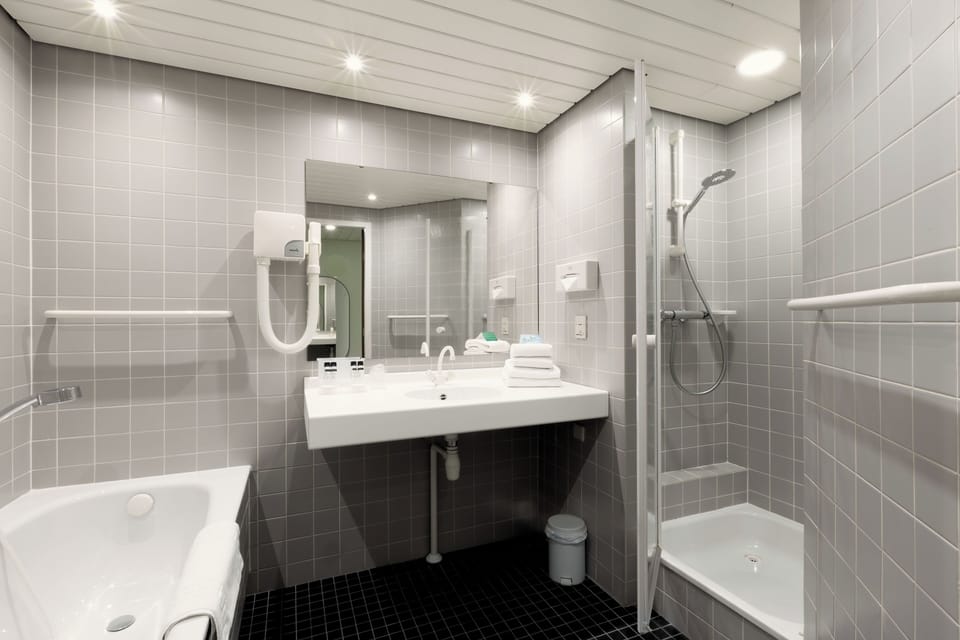 Wake up refreshed in a modern bath with roomy walk-in shower.
