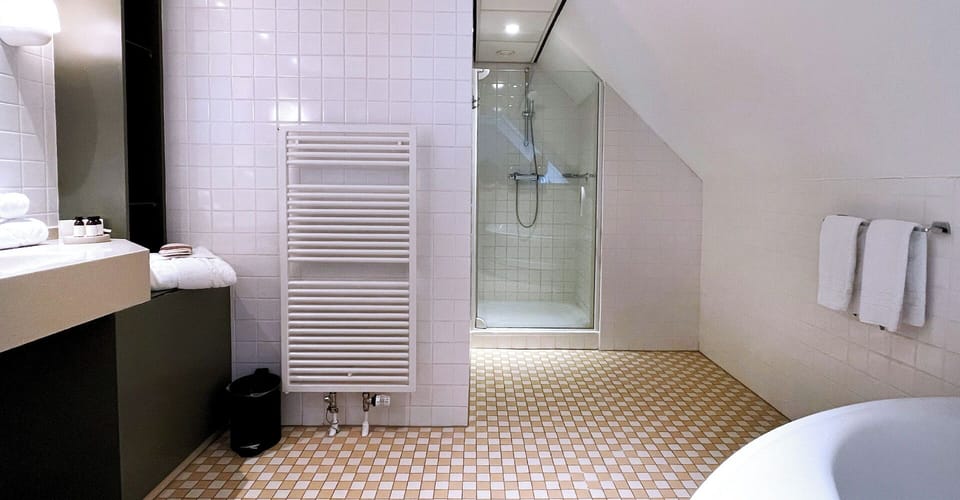 Unwind in the bright walk-in shower with fresh towels.