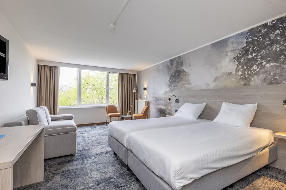 Sink into crisp bedding in a bright, modern retreat.