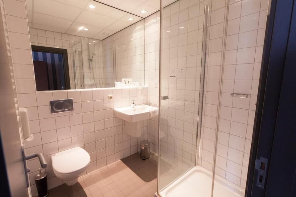 Refresh easily in a bright bathroom with glass shower.