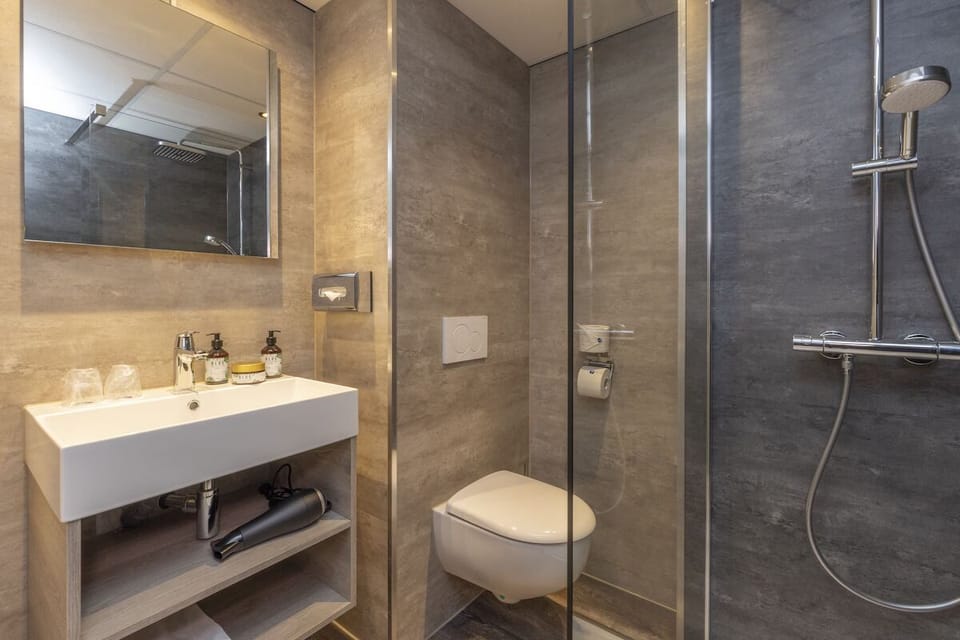 Rejuvenate in a sleek, modern bath with rainfall shower.