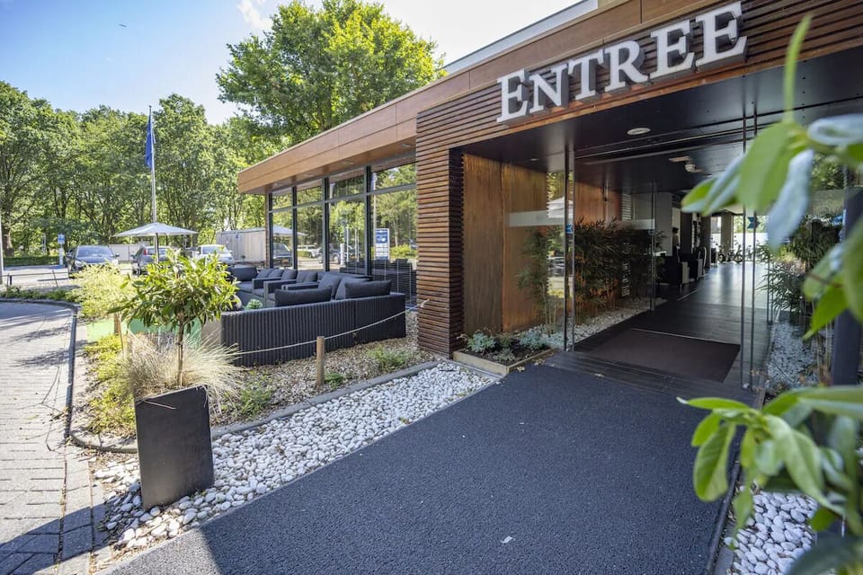 Step into a welcoming entrance framed by tranquil garden landscaping.