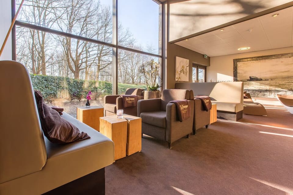 Unwind in sunlit lounge seating with tranquil garden views.