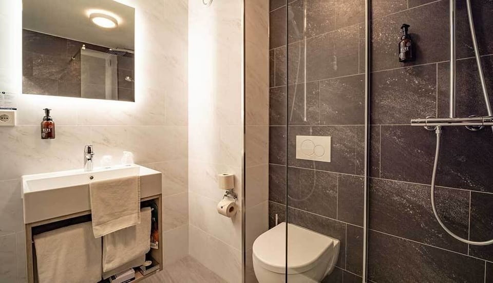 Refresh with a spotless, modern shower and bright vanity mirror.