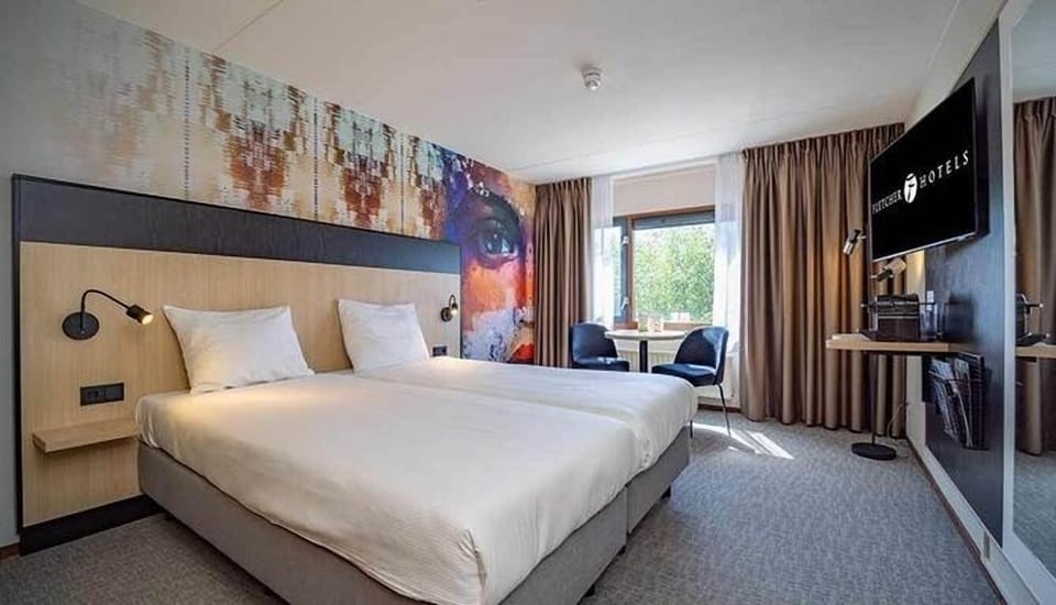 Unwind in a bright, modern room with bold art accents.