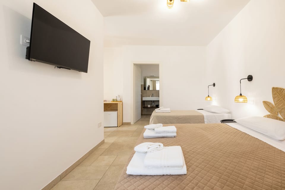 Triple Room, Private Bathroom, Garden View | Minibar, in-room safe, desk, laptop workspace