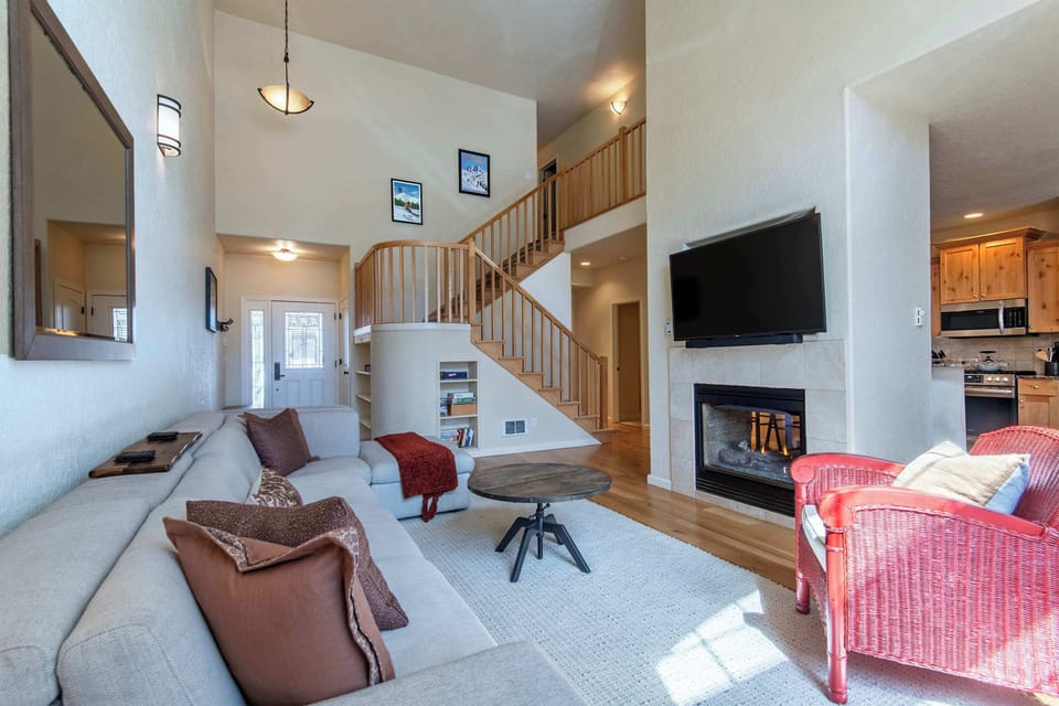 Cozy up by the fireplace in this bright, open living space