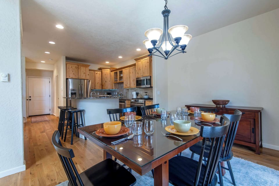 Elegant dining area with seating for six beside a well-appointed kitchen