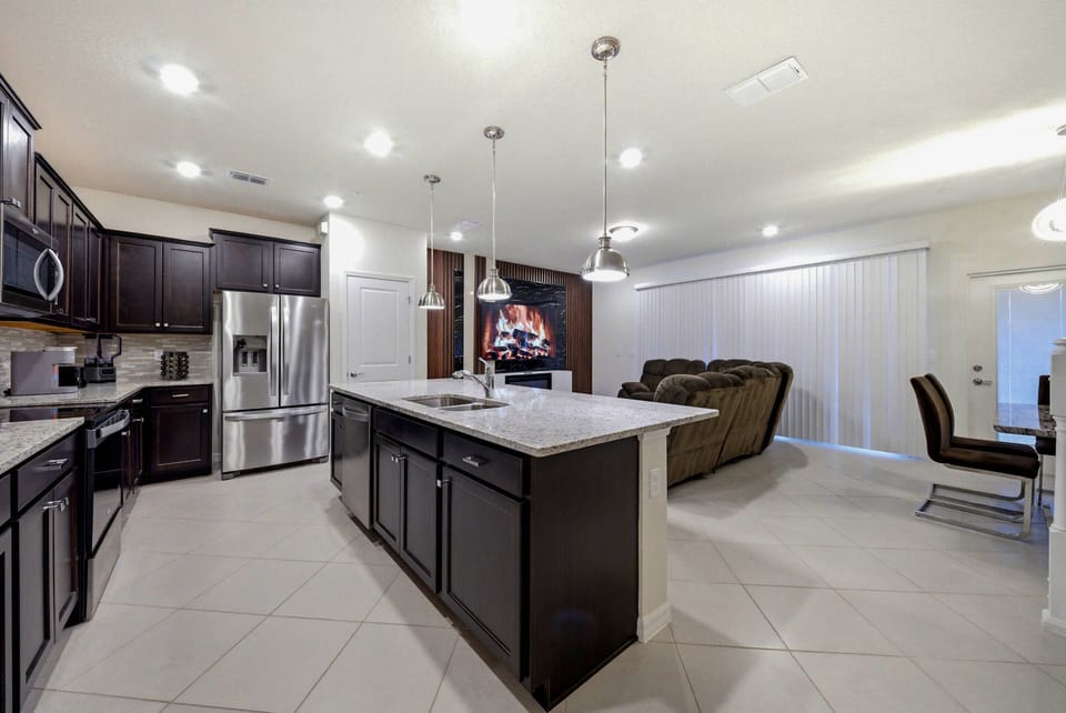 Experience the charm of this beautiful kitchen with rich dark cabinetry and sleek granite countertops, perfect for your culinary adventures.