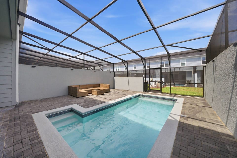 Step outside to your private oasis featuring a sparkling pool enclosed by a sleek, modern screen for ultimate relaxation. Comfortable seating invites you to unwind while soaking up the sun, surrounded by a tranquil atmosphere.