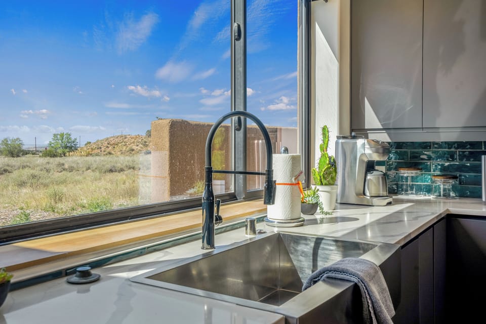 Your modern kitchen offers stunning desert views while you prepare meals, with sleek counters and natural light streaming in.