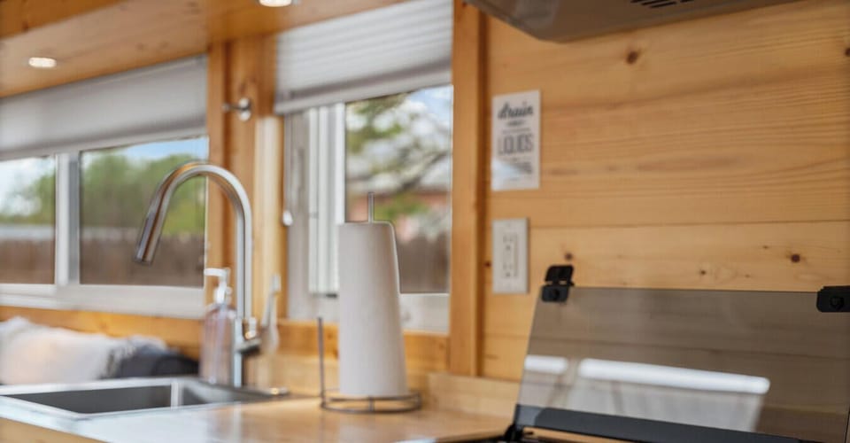 Cook with ease in this bright, stylish kitchen featuring a gas range, sleek sink, and beautiful natural wood details.