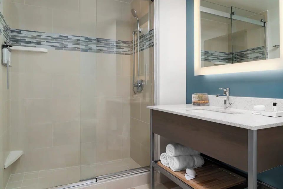 Refresh in a spotless walk-in shower with bright vanity.