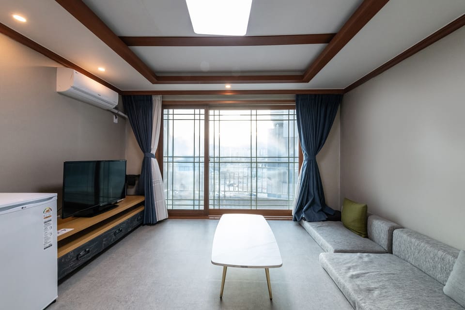 Deluxe Ondol | Living area | Flat-screen TV, heated floors