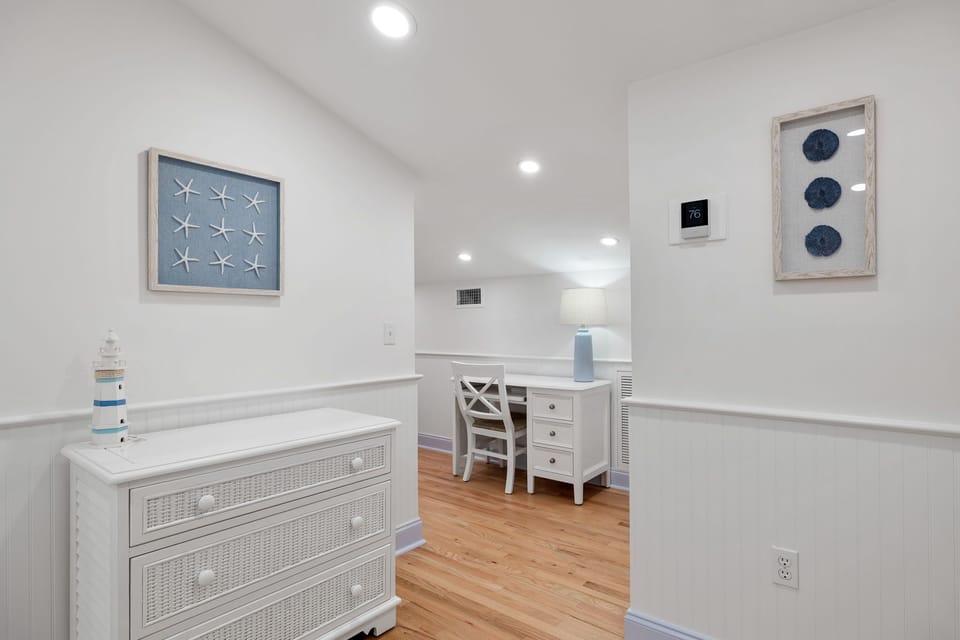 Your coastal-themed workspace awaits with charming nautical décor and warm wood floors for productive seaside mornings.