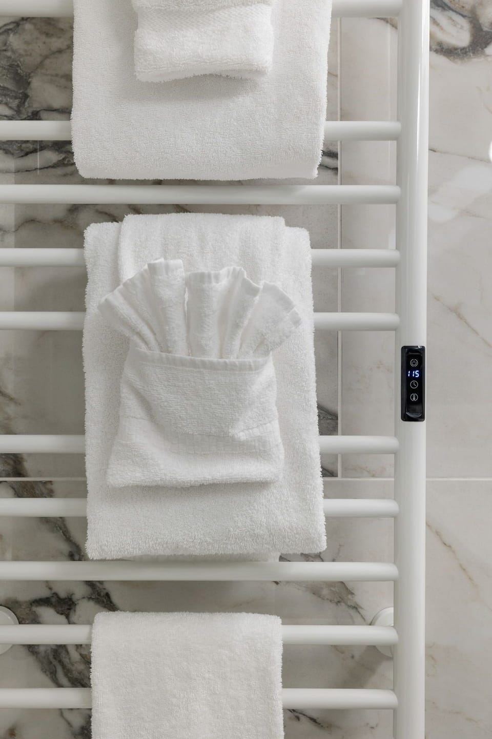 Fresh towels await on your heated towel rack, keeping everything perfectly warm and cozy for your daily routine.