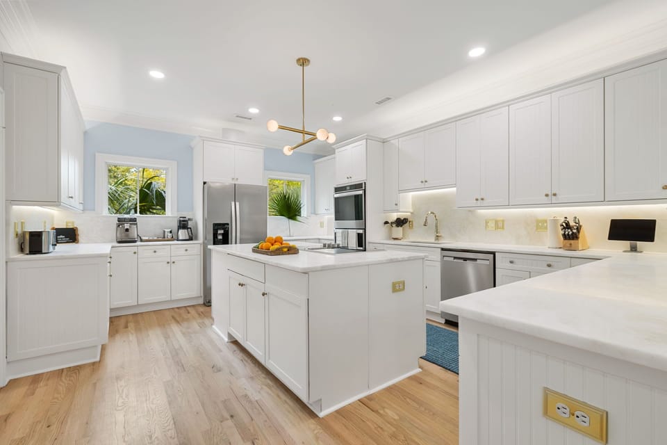 Your dream kitchen awaits with gleaming white cabinets, modern appliances, and a spacious island perfect for cooking memorable meals together.