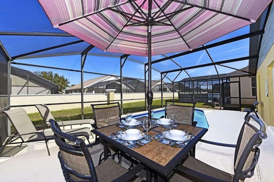 Outdoor dining area under a colorful umbrella, ideal for al fresco meals.