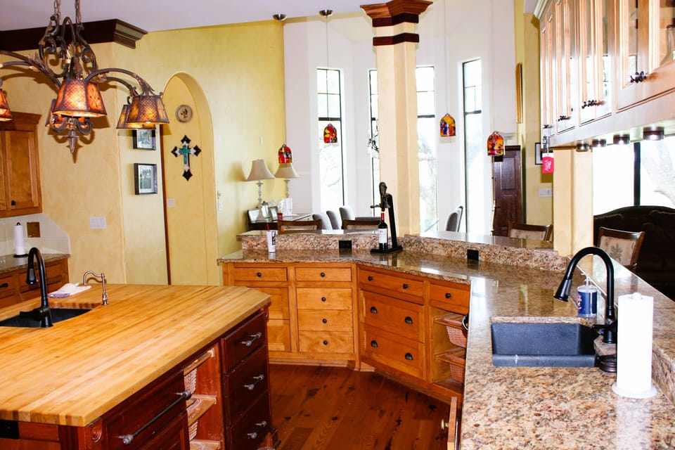 kitchen with stunning views of the oak packed property in the hill country 