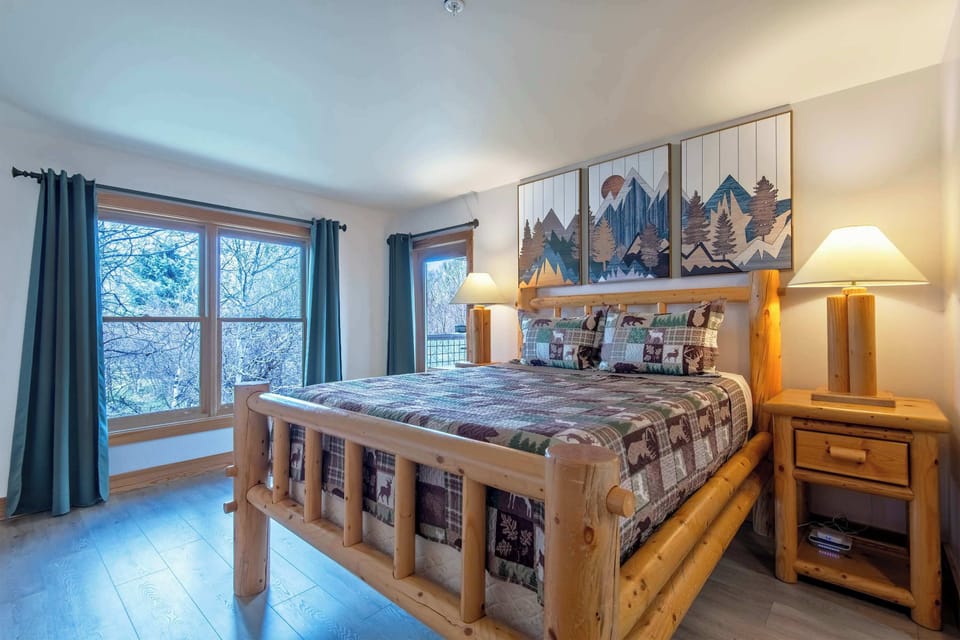 Settle into this inviting master bedroom after a day in the mountains