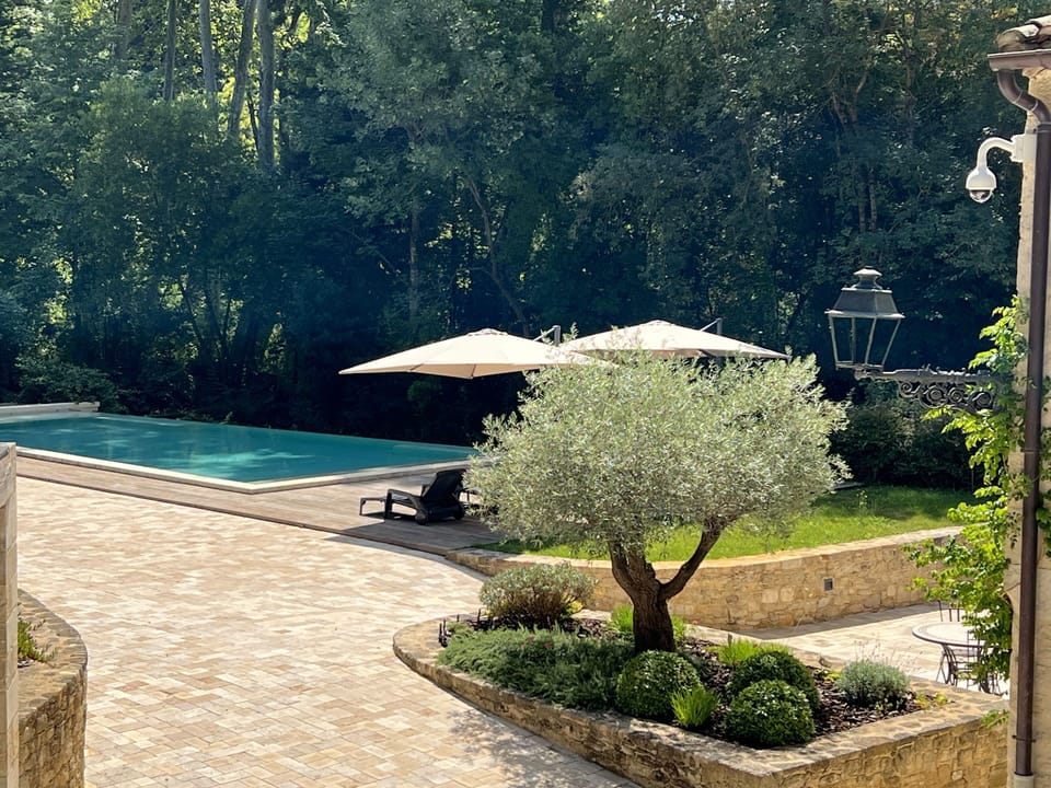 Seasonal outdoor pool, open 8:00 AM to 8:00 PM, pool umbrellas