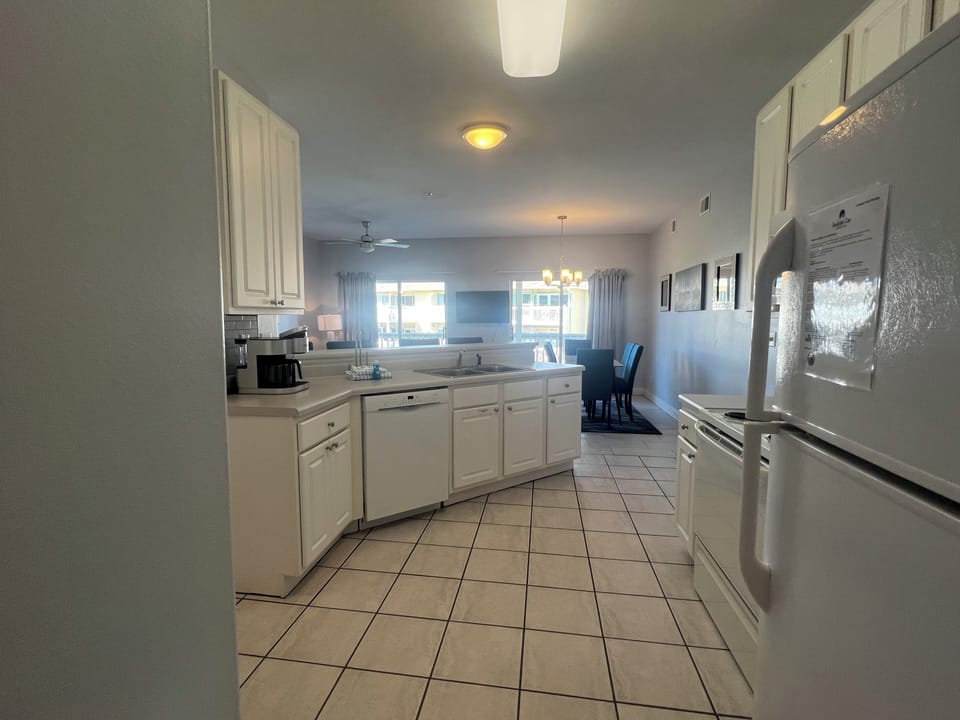 Your fully equipped kitchen awaits with white cabinets, modern appliances, and plenty of counter space for cooking memorable meals together.