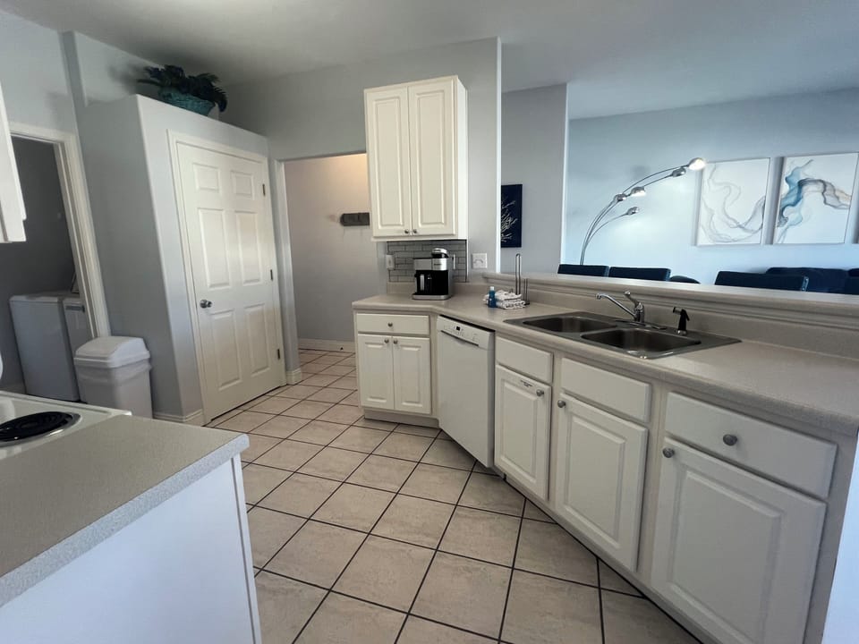 Step into your spacious kitchen where white cabinets and modern appliances await your culinary adventures.
