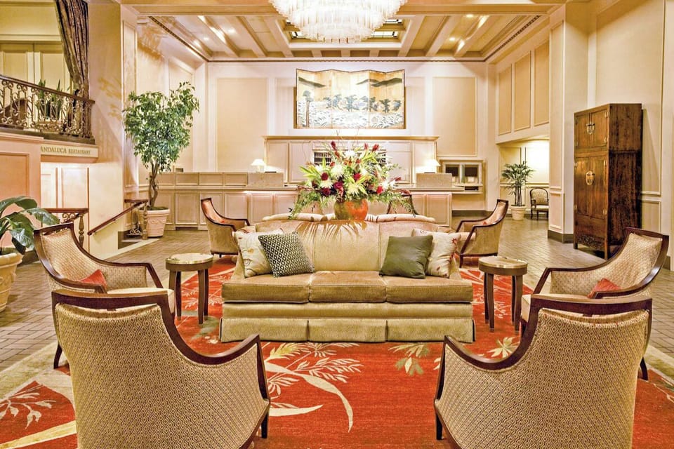 Sink into plush seating beneath a bright, airy lobby.