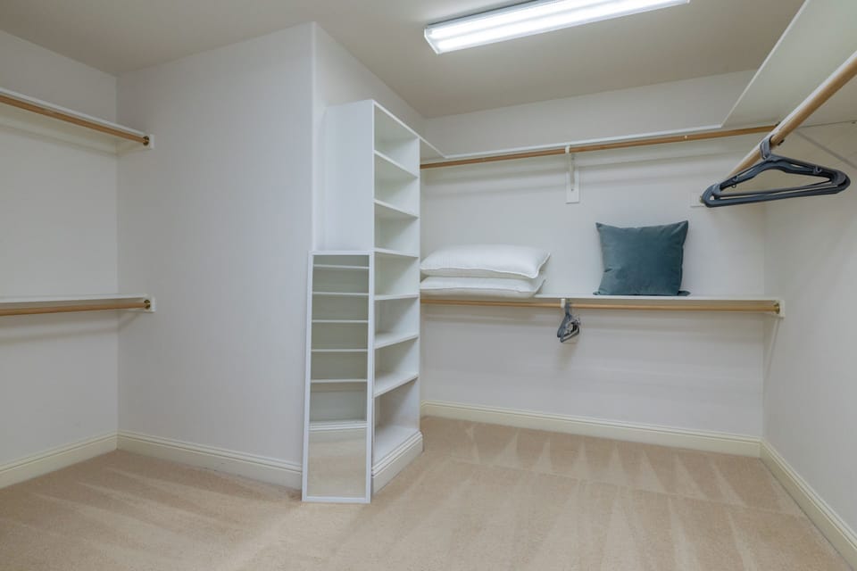 Spacious walk-in closet with shelves and hanging space for easy storage